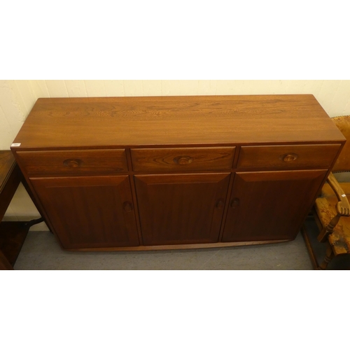 193 - An Ercol mid brown elm sideboard with three drawers and three doors, on a plinth&nbsp; 37