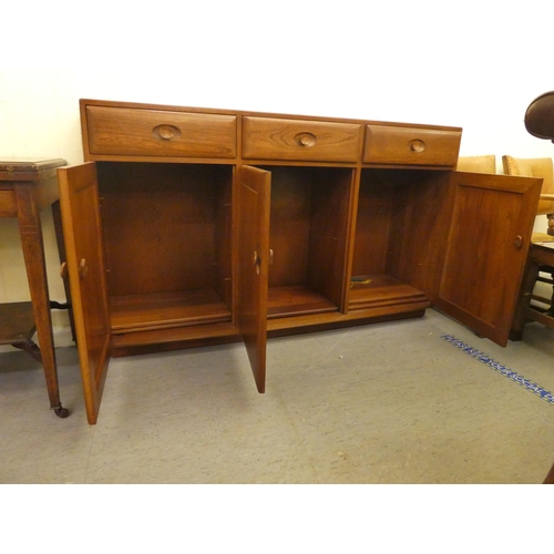 193 - An Ercol mid brown elm sideboard with three drawers and three doors, on a plinth&nbsp; 37