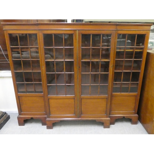 195 - An Edwardian mahogany breakfront bookcase with four astragal glazed doors, raised on bracket feet&nb... 