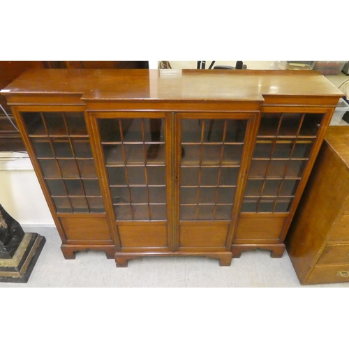 195 - An Edwardian mahogany breakfront bookcase with four astragal glazed doors, raised on bracket feet&nb... 