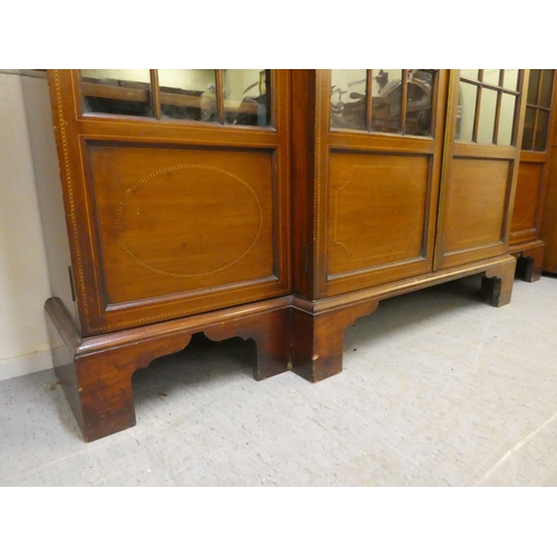 195 - An Edwardian mahogany breakfront bookcase with four astragal glazed doors, raised on bracket feet&nb... 