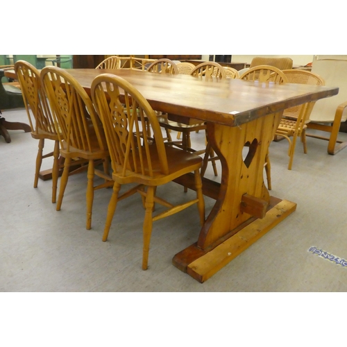 196 - A modern pine refectory design kitchen table, raised on plank ends  30