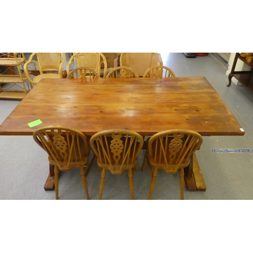 196 - A modern pine refectory design kitchen table, raised on plank ends  30