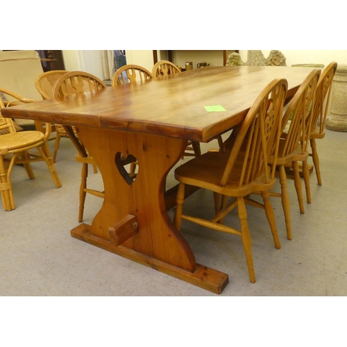 196 - A modern pine refectory design kitchen table, raised on plank ends  30