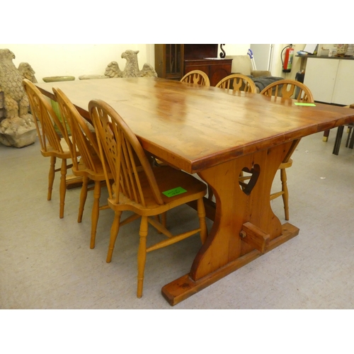 196 - A modern pine refectory design kitchen table, raised on plank ends  30
