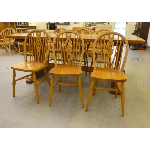 196 - A modern pine refectory design kitchen table, raised on plank ends  30