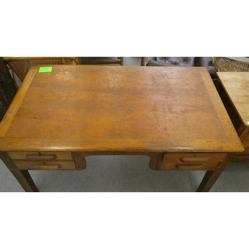 197 - A 1930s oak desk with four drawers, raised on block legs&nbsp; 30