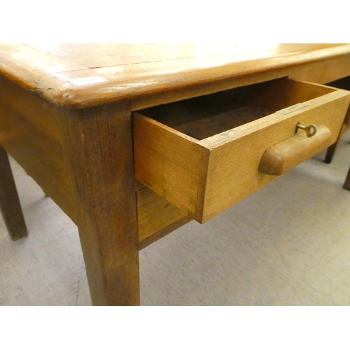 197 - A 1930s oak desk with four drawers, raised on block legs&nbsp; 30