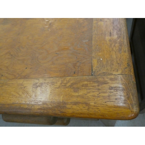 197 - A 1930s oak desk with four drawers, raised on block legs&nbsp; 30