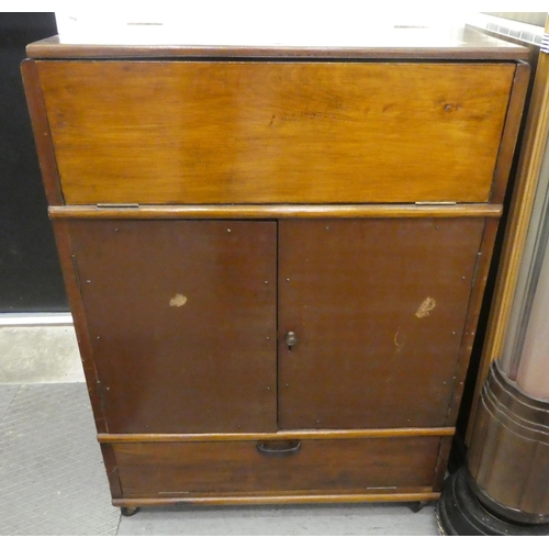 202 - A 1950s fruitwood cocktail cabinet with a rise and fall top, over two doors, raised on casters  38