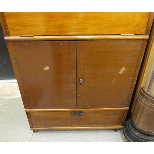 202 - A 1950s fruitwood cocktail cabinet with a rise and fall top, over two doors, raised on casters  38