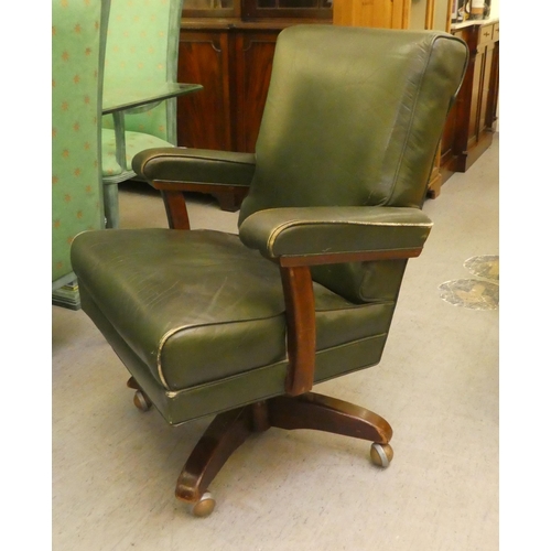 206 - A mid 20thC faux green hide upholstered swivel office chair, raised on a splayed pedestal base
