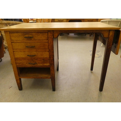 207 - A modern oak single pedestal desk with four drawers, raised on block legs&nbsp; 29