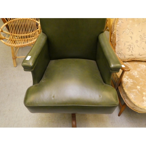 211 - A mid 20thC faux green hide upholstered swivel office chair, raised on a splayed pedestal base
