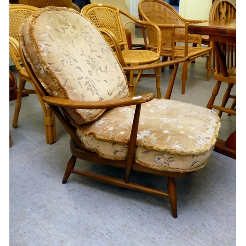 212 - An Ercol mid brown elm spindle back armchair, raised on turned legs&nbsp;