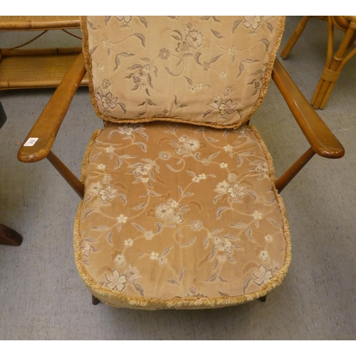 212 - An Ercol mid brown elm spindle back armchair, raised on turned legs&nbsp;