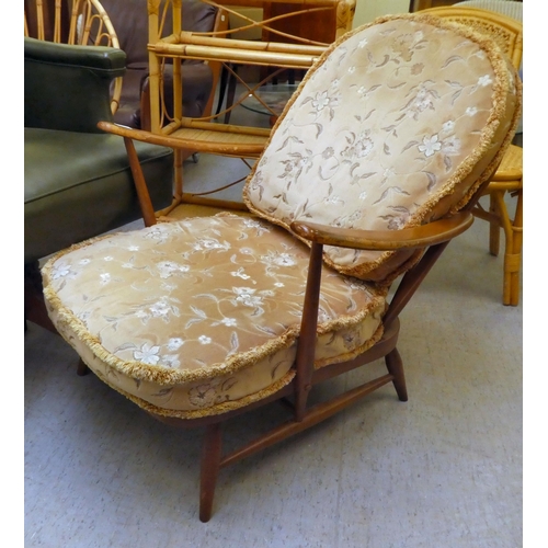 212 - An Ercol mid brown elm spindle back armchair, raised on turned legs&nbsp;