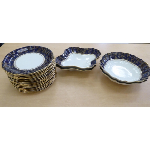 217 - An early 20thC Wedgwood china dessert service, decorated with a gilded blue band&nbsp;