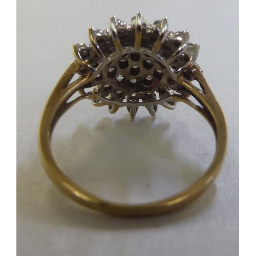 224 - A gold coloured metal diamond set star design cluster ring&nbsp;