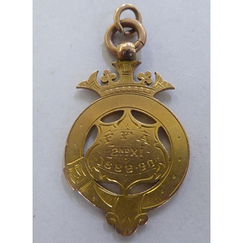 228 - A late Victorian 9ct gold pendant football medal&nbsp; 1889&nbsp;