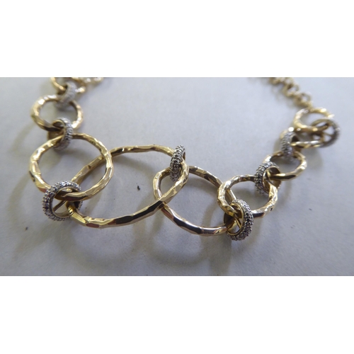 234 - A 9ct gold rustic design bi-coloured diamond set bracelet&nbsp;