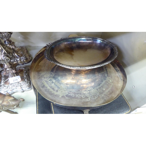 236 - Metalware: to include a pair of silver plated candlesticks, embossed with swags  8