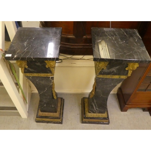 25 - A pair of 19thC Continentally inspired, modular, marble pedestals of square, tapered form with gilt ... 