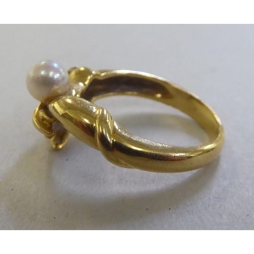 250 - An 18ct gold friendship ring, set with a cultured pearl&nbsp;