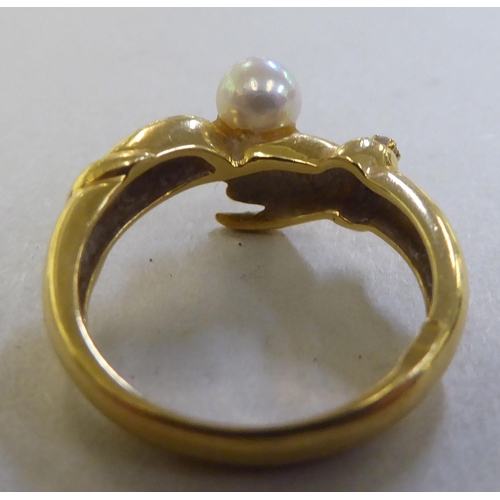 250 - An 18ct gold friendship ring, set with a cultured pearl&nbsp;