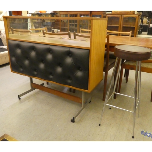 261 - A 1960s laminate bar with a glazed upper section, raised on metal legs  38