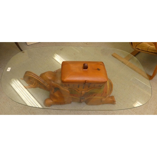 265 - A modern teak framed coffee table, the base fashioned as an elephant with a glass top  14