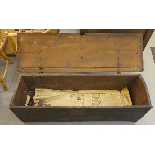 270 - A mid 18thC boarded oak chest with a hinged lid, raised on planked feet  17