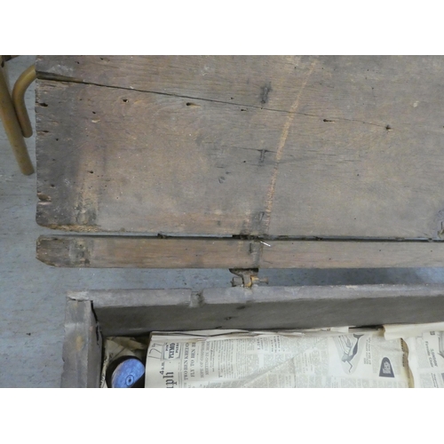 270 - A mid 18thC boarded oak chest with a hinged lid, raised on planked feet  17