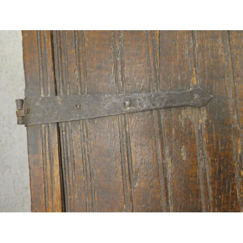 270 - A mid 18thC boarded oak chest with a hinged lid, raised on planked feet  17