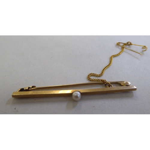 277 - A 9ct gold bar brooch, set with a single pearl  boxed