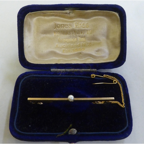 277 - A 9ct gold bar brooch, set with a single pearl  boxed