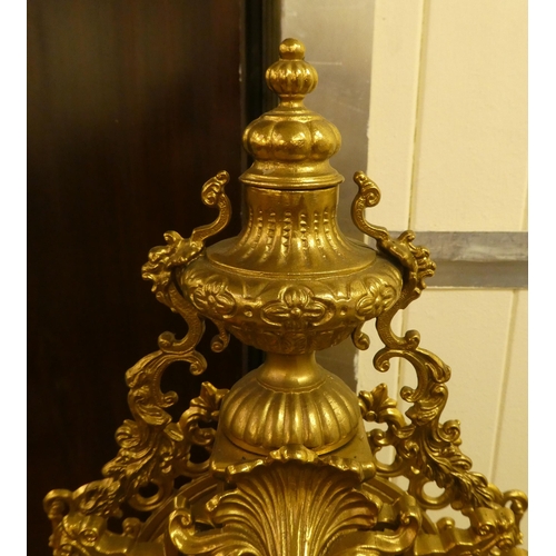 285 - A modern Victorian design, gilt metal cased mantel clock of ornate architectural design, faced by a ... 