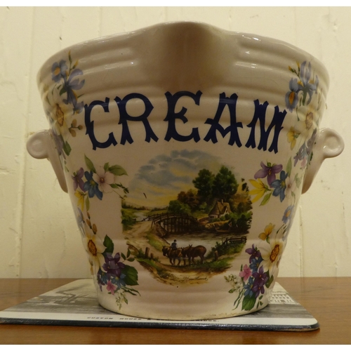 300 - An Ironstone china twin handled milk pail of tapered form; and a matching cream crock