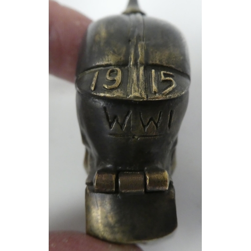 44 - A brass vesta case, fashioned as a skull wearing a pickelhaube