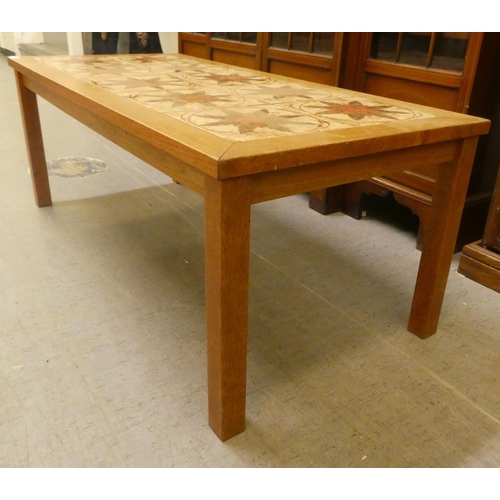 45 - A 1970s teak framed ten tile top coffee table, raised on square legs  17