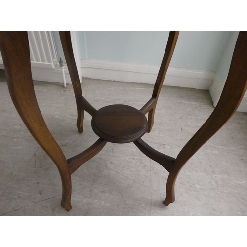 60 - A mid 20thC mahogany occasional table, having a serpentine outlined top, raised on cabriole legs, un... 