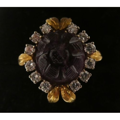 65 - An 18ct gold, claw set, amethyst and diamond cluster ring