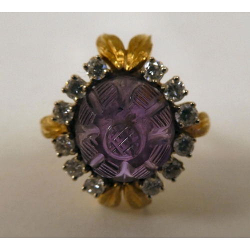 65 - An 18ct gold, claw set, amethyst and diamond cluster ring