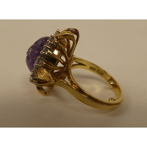 65 - An 18ct gold, claw set, amethyst and diamond cluster ring