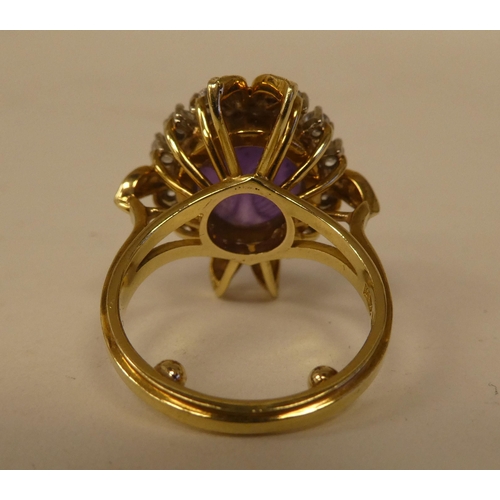 65 - An 18ct gold, claw set, amethyst and diamond cluster ring