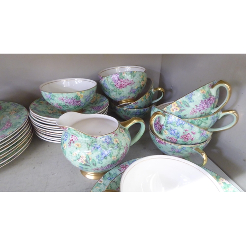 67 - British Empire Chintz china Lilac Time pattern teaware, comprising a teapot, saucer, milk jug, cups,... 