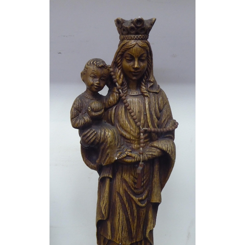 73 - A Continental faux carved wooden moulded, pottery figure 'Madonna and the Christ Child'  19