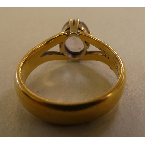 83 - A 22ct gold ring, claw set with a smoky white stone