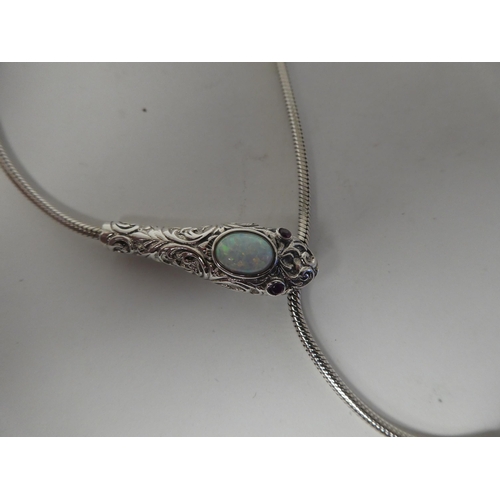 89 - A silver coloured metal, opal set snake necklace with ruby set eyes