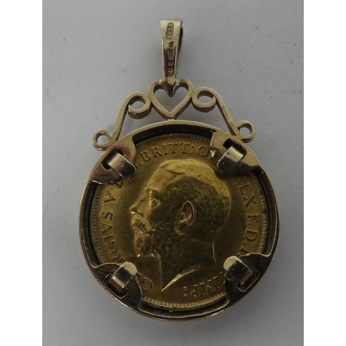 94 - A George V half sovereign, St George on the obverse  1914, in a 9ct gold, scrolled pendant moun... 